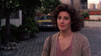 Movie still from “Terms of Endearment” (1983), directed by James L. Brooks – A young woman standing on the sidewalk in front of a taxi cab; Close Up shot, Over the shoulder angle