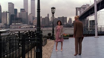 Movie still from “Terms of Endearment” (1983), directed by James L. Brooks – Two people standing on a walkway near a river; Wide shot, Over the shoulder angle