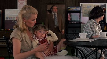 Movie still from “Terms of Endearment” (1983), directed by James L. Brooks – A woman holding a baby in her lap; Medium shot, Over the shoulder angle