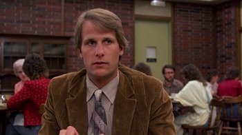 Movie still from “Terms of Endearment” (1983), directed by James L. Brooks – A man in a brown jacket and a tie; Close Up shot, Low angle