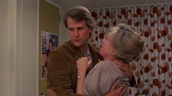 Movie still from “Terms of Endearment” (1983), directed by James L. Brooks – A man and a woman hugging in a room; Close Up shot, Over the shoulder angle