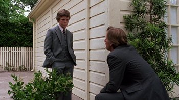 Movie still from “Terms of Endearment” (1983), directed by James L. Brooks – Two young men in business suits talking to each other; Medium shot, Over the shoulder angle