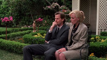 Movie still from “Terms of Endearment” (1983), directed by James L. Brooks – A man and a woman sitting next to each other on a park bench; Medium shot, Low angle