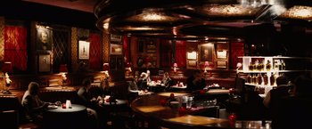 Movie still from “Thank You for Smoking” (2005), directed by Jason Reitman – People are sitting at a bar in a restaurant; Wide shot, High angle