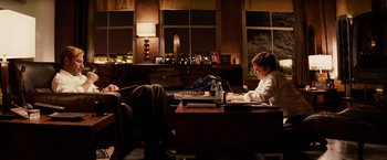 Movie still from “Thank You for Smoking” (2005), directed by Jason Reitman – A woman sitting at a table with a laptop; Wide shot, Over the shoulder angle