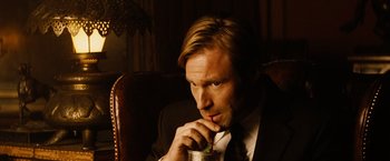 Movie still from “Thank You for Smoking” (2005), directed by Jason Reitman – A man sitting in a chair holding a drink; Close Up shot, High angle
