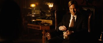 Movie still from “Thank You for Smoking” (2005), directed by Jason Reitman – A man sitting in a chair holding a can of soda; Medium shot, Over the shoulder angle