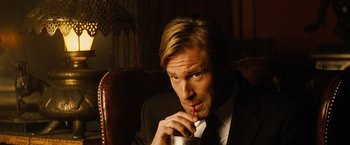 Movie still from “Thank You for Smoking” (2005), directed by Jason Reitman – A person sitting in a chair holding a drink; Close Up shot, High angle