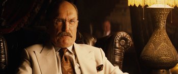 Movie still from “Thank You for Smoking” (2005), directed by Jason Reitman – An older man in a suit and tie sitting in a leather chair; Close Up shot, Low angle