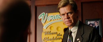 Movie still from “Thank You for Smoking” (2005), directed by Jason Reitman – A man standing in front of a sign for vermont cheese; Close Up shot, Over the shoulder angle