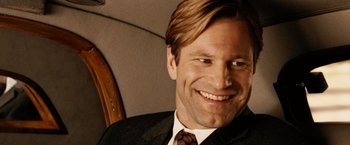 Movie still from “Thank You for Smoking” (2005), directed by Jason Reitman – A person wearing a suit and tie smiling; Close Up shot, Over the shoulder angle