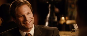 Movie still from “Thank You for Smoking” (2005), directed by Jason Reitman – A man wearing a suit and tie smiling for the camera; Close Up shot, Over the shoulder angle
