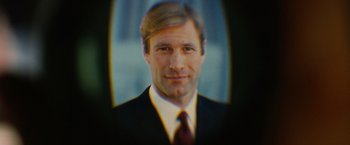 Movie still from “Thank You for Smoking” (2005), directed by Jason Reitman – A man wearing a suit and tie with his head tilted to the side; Extreme Close Up shot, Low angle