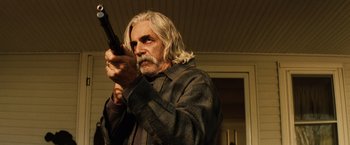 Movie still from “Thank You for Smoking” (2005), directed by Jason Reitman – An older man holding a gun while standing in front of a building; Medium shot, Low angle