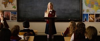 Movie still from “Thank You for Smoking” (2005), directed by Jason Reitman – A girl in a red and blue uniform is giving a speech; Medium shot, Over the shoulder angle