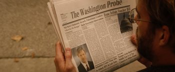 Movie still from “Thank You for Smoking” (2005), directed by Jason Reitman – A person holding a newspaper in front of a wall; Extreme Close Up shot, High angle