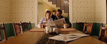Movie still from “Thank You for Smoking” (2005), directed by Jason Reitman – A man and a woman sitting at a table reading a newspaper; Medium shot, Over the shoulder angle