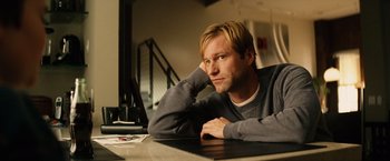 Movie still from “Thank You for Smoking” (2005), directed by Jason Reitman – A man sitting at a table with his hand on his chin; Close Up shot, Low angle