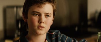 Movie still from “Thank You for Smoking” (2005), directed by Jason Reitman – A young boy's face with green eyes; Close Up shot, Over the shoulder angle