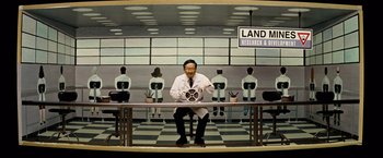 Movie still from “Thank You for Smoking” (2005), directed by Jason Reitman – A man sitting on top of a table in front of other people; Wide shot, High angle