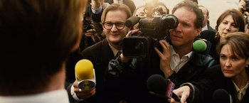Movie still from “Thank You for Smoking” (2005), directed by Jason Reitman – A man is being interviewed by a crowd of people; Close Up shot, Over the shoulder angle