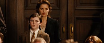 Movie still from “Thank You for Smoking” (2005), directed by Jason Reitman – A woman standing next to a young boy in a suit; Close Up shot, Low angle
