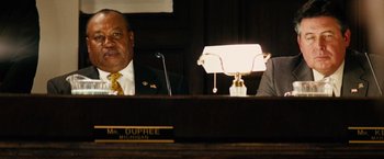 Movie still from “Thank You for Smoking” (2005), directed by Jason Reitman – Two men sitting at a table in front of microphones; Close Up shot, Low angle