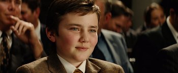 Movie still from “Thank You for Smoking” (2005), directed by Jason Reitman – A boy in a suit and tie smiling for the camera; Close Up shot, Over the shoulder angle