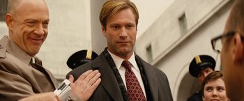 Movie still from “Thank You for Smoking” (2005), directed by Jason Reitman – A man in a suit and tie saluting with his right hand; Close Up shot, Over the shoulder angle