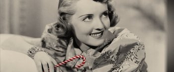 Movie still from “Thank You for Smoking” (2005), directed by Jason Reitman – An old photo of a woman holding a candy cane; Extreme Close Up shot, Overhead angle