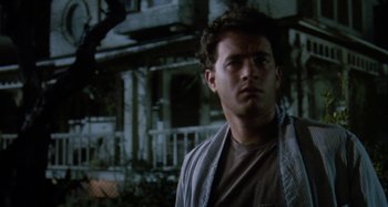 Movie still from “The 'Burbs” (1989), directed by Joe Dante – A man standing in front of an old building; Close Up shot, Low angle