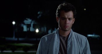 Movie still from “The 'Burbs” (1989), directed by Joe Dante – A man that is standing in the dark outside at night; Close Up shot, Low angle