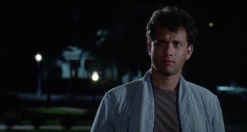 Movie still from “The 'Burbs” (1989), directed by Joe Dante – A man standing in the middle of the street at night; Close Up shot, Low angle