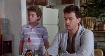 Movie still from “The 'Burbs” (1989), directed by Joe Dante – A man and a boy sitting at a kitchen table; Close Up shot, Over the shoulder angle
