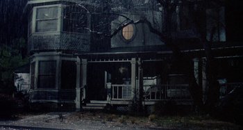 Movie still from “The 'Burbs” (1989), directed by Joe Dante – A house that has a clock on the outside of it; Wide shot, Low angle