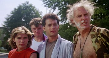 Movie still from “The 'Burbs” (1989), directed by Joe Dante – A group of people standing next to each other in front of trees; Close Up shot, Low angle
