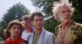 Movie still from “The 'Burbs” (1989), directed by Joe Dante – A group of people standing next to each other in front of trees; Close Up shot, Low angle