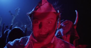 Movie still from “The 'Burbs” (1989), directed by Joe Dante – A man in a pink suit and a bow tie; Close Up shot, Low angle
