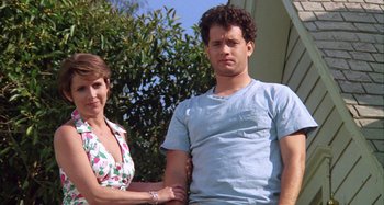 Movie still from “The 'Burbs” (1989), directed by Joe Dante – A man and a woman standing next to each other outside; Medium shot, Low angle