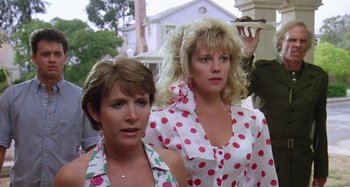 Movie still from “The 'Burbs” (1989), directed by Joe Dante – A couple of women standing next to each other on a street; Medium shot, Low angle