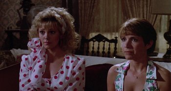 Movie still from “The 'Burbs” (1989), directed by Joe Dante – A couple of women sitting next to each other in a room; Close Up shot, Low angle