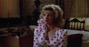 Movie still from “The 'Burbs” (1989), directed by Joe Dante – A woman in a polka dot shirt and a headband; Medium shot, Over the shoulder angle