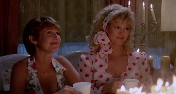 Movie still from “The 'Burbs” (1989), directed by Joe Dante – A couple of women sitting at a table with cups; Medium shot, Low angle