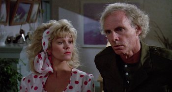 Movie still from “The 'Burbs” (1989), directed by Joe Dante – A man and a woman standing next to each other in a room; Close Up shot, Low angle