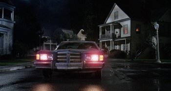 Movie still from “The 'Burbs” (1989), directed by Joe Dante – A car parked in front of a house at night; Wide shot, Low angle