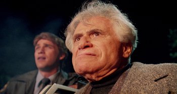 Movie still from “The 'Burbs” (1989), directed by Joe Dante – An older man with a gray hair and a beard; Close Up shot, Low angle