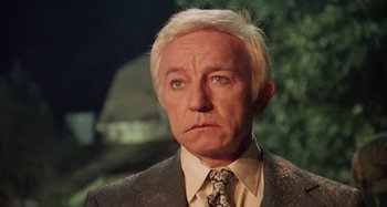 Movie still from “The 'Burbs” (1989), directed by Joe Dante – An older man wearing a suit and tie; Close Up shot, Low angle