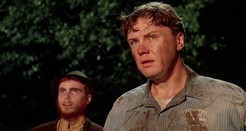 Movie still from “The 'Burbs” (1989), directed by Joe Dante – Two men are standing in front of a tree; Close Up shot, Low angle