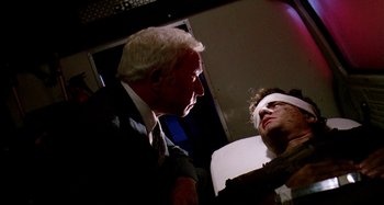 Movie still from “The 'Burbs” (1989), directed by Joe Dante – A man with a blindfold talking to another man; Close Up shot, Low angle