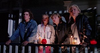 Movie still from “The 'Burbs” (1989), directed by Joe Dante – A group of people standing next to each other with lit candles; Medium shot, Low angle
